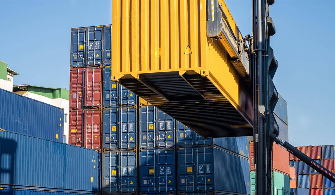 Container Lifted Onto Pile at Yard