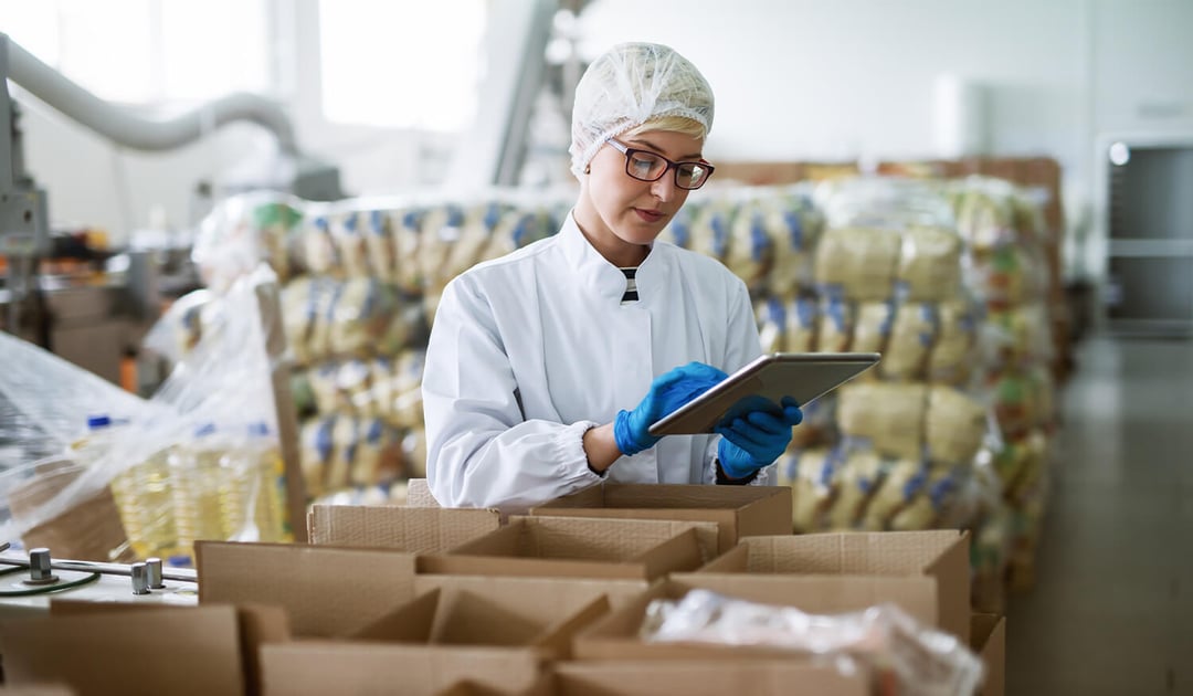 Female Worker in Food Warehouse Checking Shipment